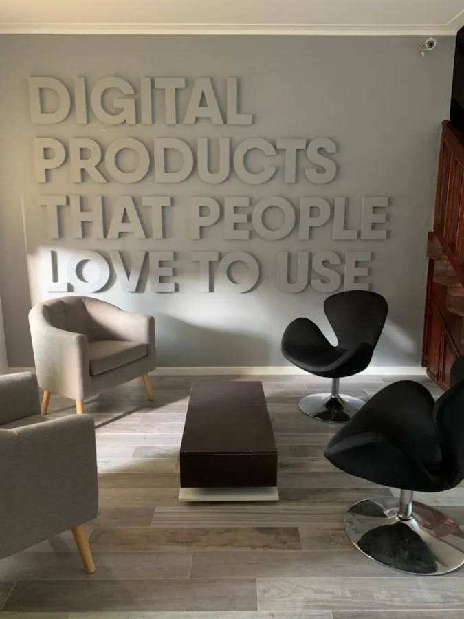 QKStudio's lounge with the phrase "Digital products that people love to use" on the wall
